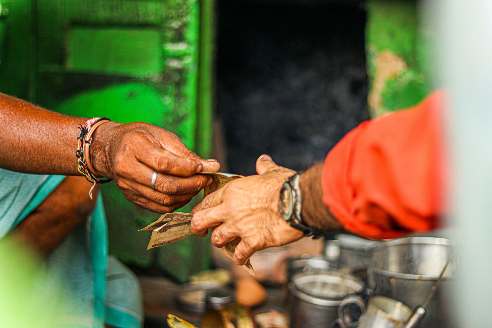 a person handing another person money from a container